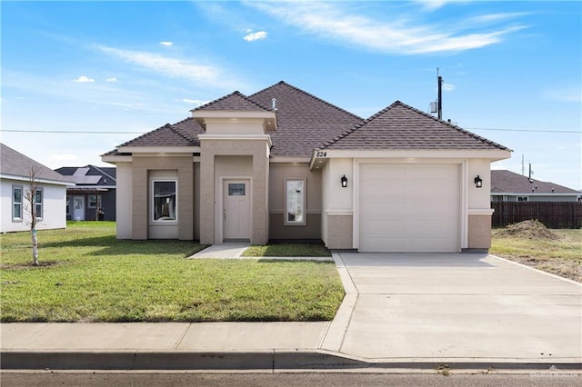 view of front facade featuring a front lawn and a garage