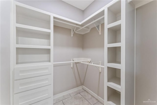 walk in closet featuring light tile patterned floors