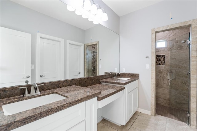 bathroom featuring a shower with door, vanity, and tile patterned floors