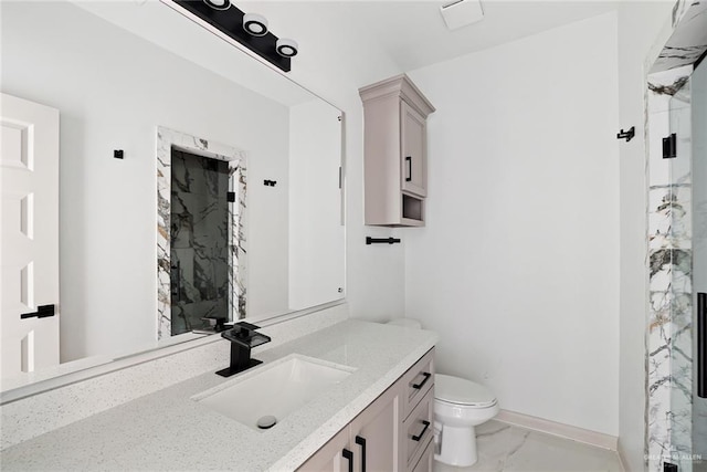 full bathroom with a marble finish shower, baseboards, toilet, marble finish floor, and vanity