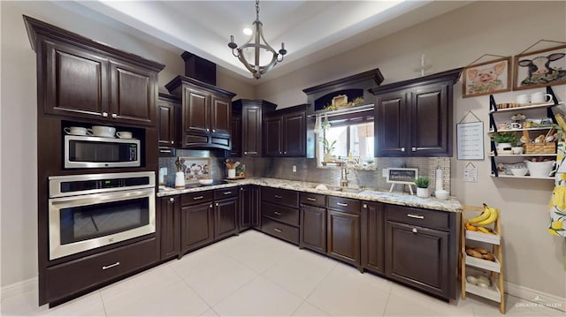 843 Brady Ave, Alamo, TX 78516 - kitchen featuring dark brown cabinets, a sink, decorative backsplash, appliances with stainless steel finishes, and light stone countertops