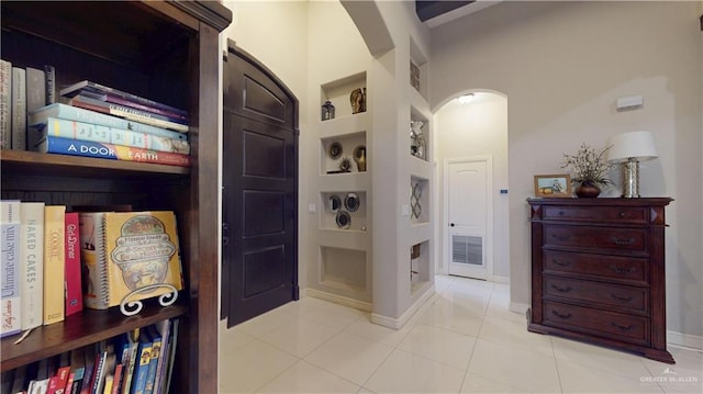 843 Brady Ave, Alamo, TX 78516 - corridor featuring tile patterned flooring, built in features, arched walkways, and visible vents