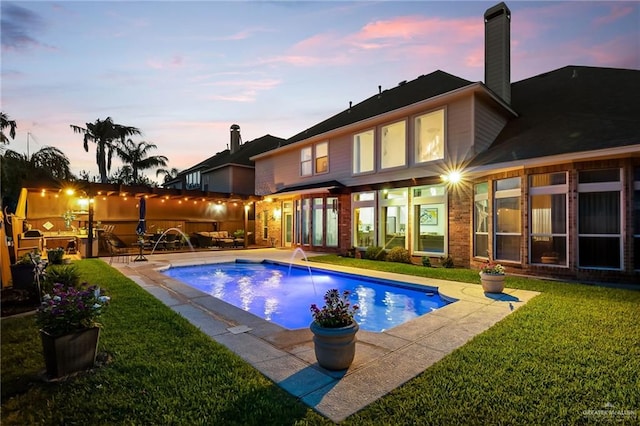 2800 San Ricardo St, Mission, TX 78572 - pool at dusk featuring a lawn, a patio area, and an outdoor pool