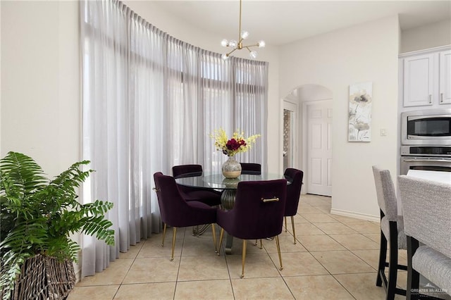 2800 San Ricardo St, Mission, TX 78572 - dining area featuring arched walkways, a chandelier, and light tile patterned floors