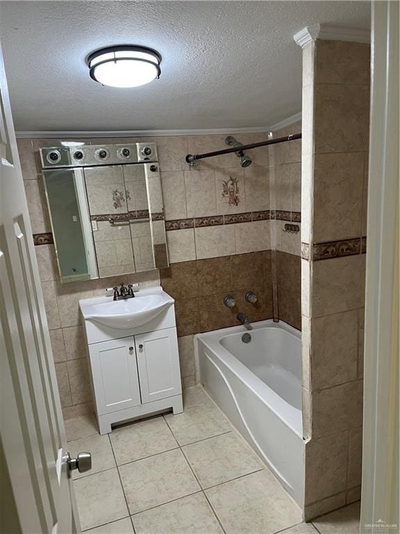 bathroom featuring tile patterned floors, vanity, tiled shower / bath combo, and a textured ceiling