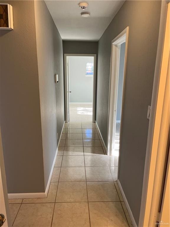 hall featuring light tile patterned floors