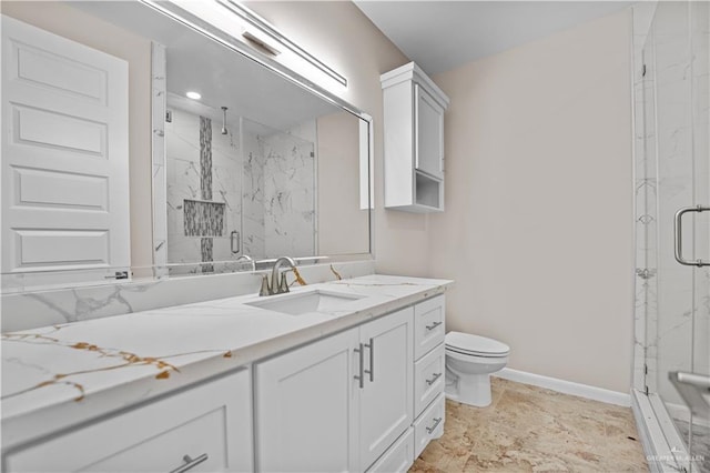 bathroom with vanity, toilet, and a shower with shower door