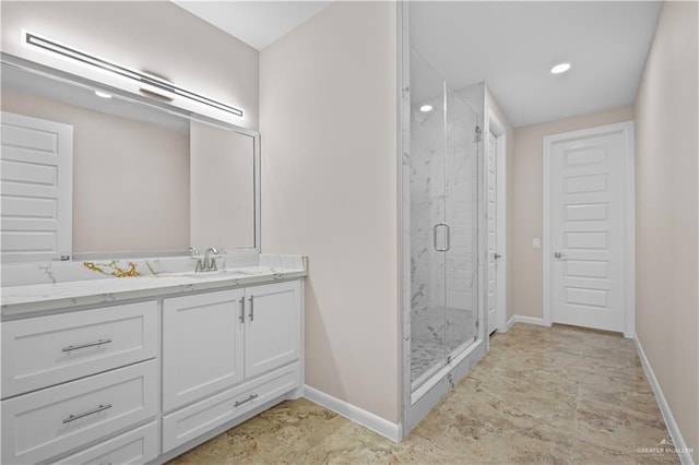 bathroom featuring vanity and a shower with shower door