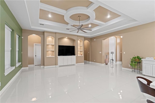 unfurnished living room with light tile patterned flooring, coffered ceiling, built in features, and ceiling fan