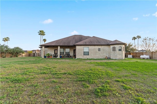 back of house featuring a yard