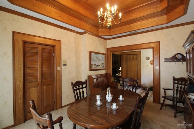 dining space featuring a tray ceiling, crown molding, light colored carpet, and an inviting chandelier