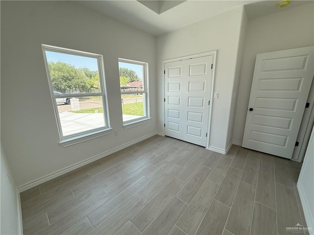 unfurnished bedroom featuring baseboards and light wood finished floors
