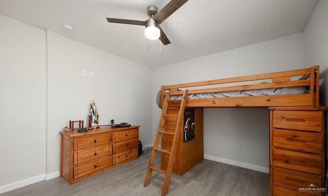 bedroom with ceiling fan and wood-type flooring