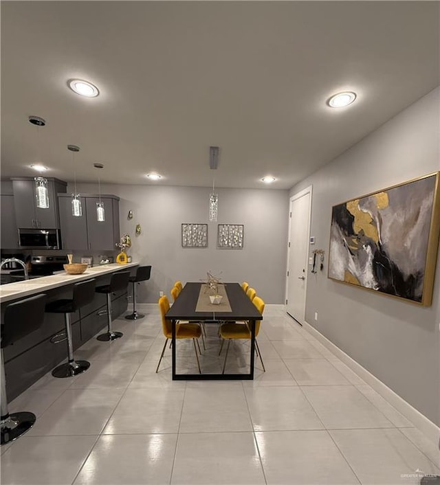 dining space featuring recessed lighting, light tile patterned flooring, and baseboards