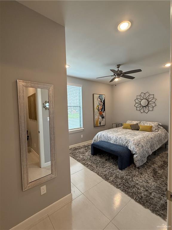 bedroom featuring a ceiling fan, recessed lighting, baseboards, and tile patterned floors