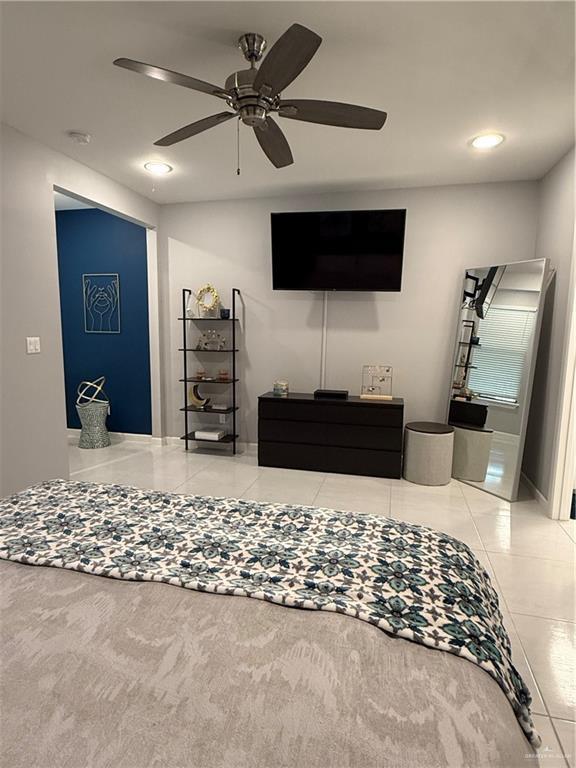 tiled living room featuring a ceiling fan and recessed lighting