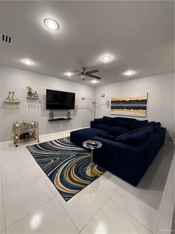 tiled living area featuring recessed lighting, visible vents, ceiling fan, and baseboards