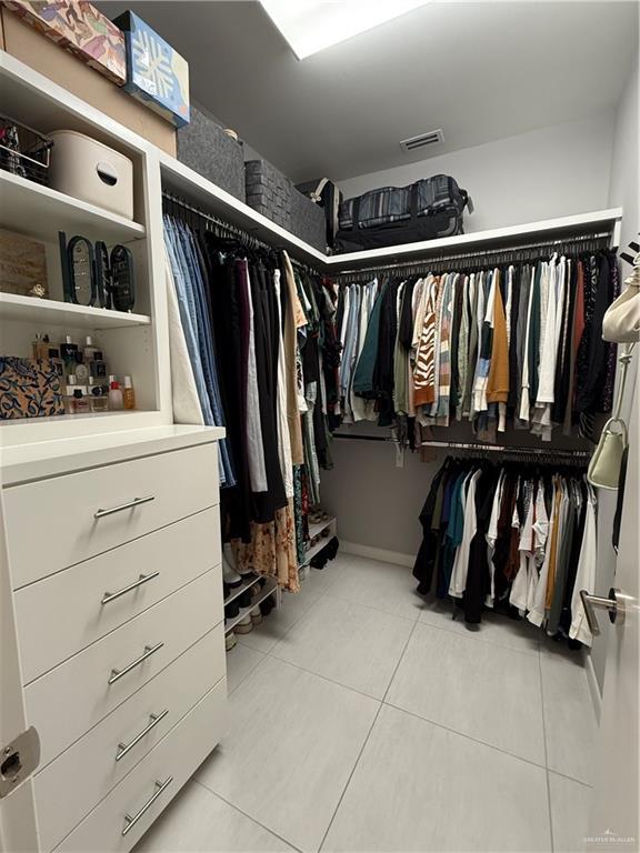 spacious closet featuring light tile patterned floors and visible vents