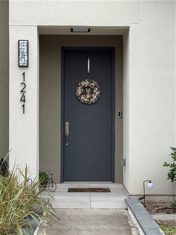 property entrance featuring stucco siding