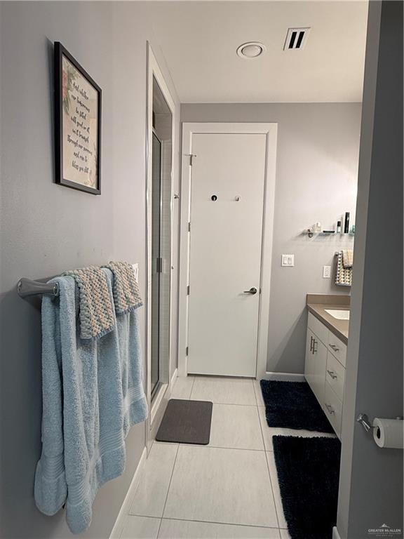 bathroom with a stall shower, visible vents, vanity, and tile patterned floors