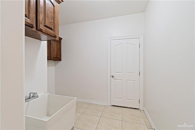 3213 Academy Ave, Edinburg, TX 78541 - laundry area with light tile patterned floors and a sink
