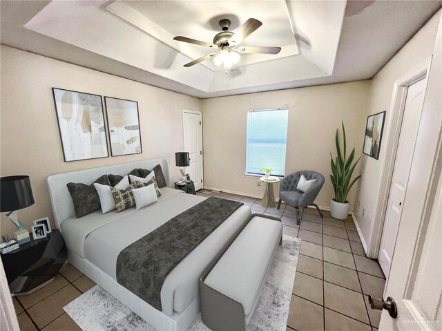 bedroom with ceiling fan, a raised ceiling, and light tile patterned floors