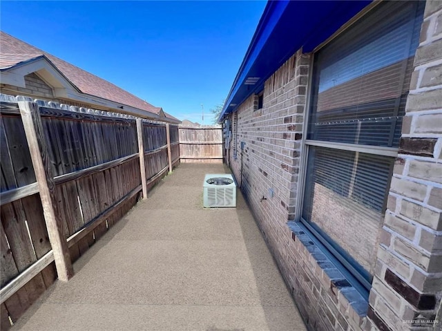 view of side of home with central air condition unit