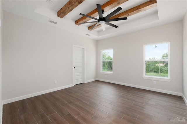 604 Windcrest Dr, Weslaco, TX 78596 - unfurnished room with visible vents, baseboards, beamed ceiling, a tray ceiling, and dark wood-type flooring