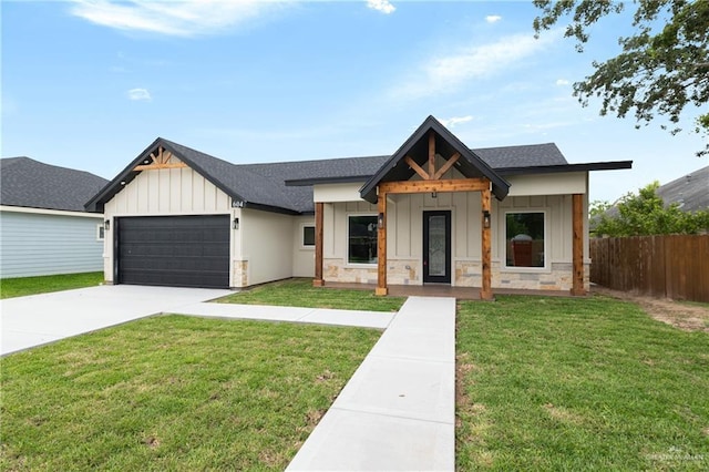 604 Windcrest Dr, Weslaco, TX 78596 - modern farmhouse featuring board and batten siding, roof with shingles, fence, an attached garage, and stone siding