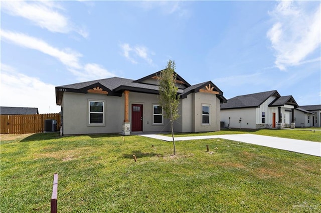 view of front of property with a front yard and central AC unit