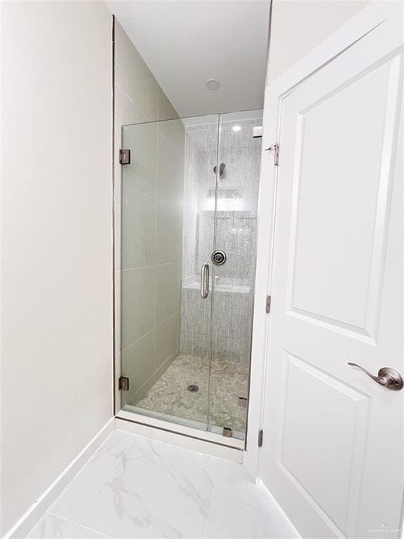 2309 S Cartier Dr, Edinburg, TX 78542 - bathroom with a shower stall, marble look tile flooring, and baseboards