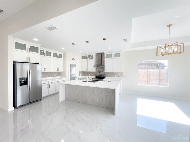 2309 S Cartier Dr, Edinburg, TX 78542 - kitchen featuring stainless steel appliances, wall chimney exhaust hood, backsplash, a chandelier, and recessed lighting