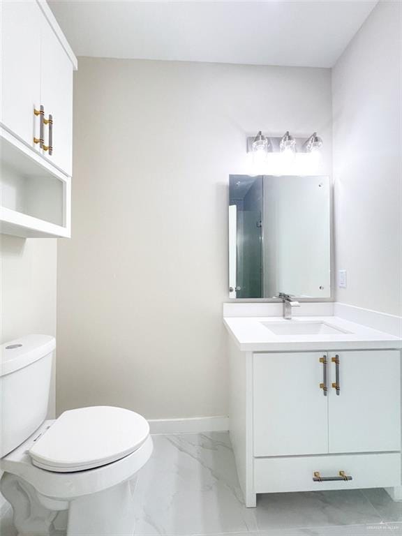 2309 S Cartier Dr, Edinburg, TX 78542 - bathroom with marble look tiles, toilet, vanity, and baseboards