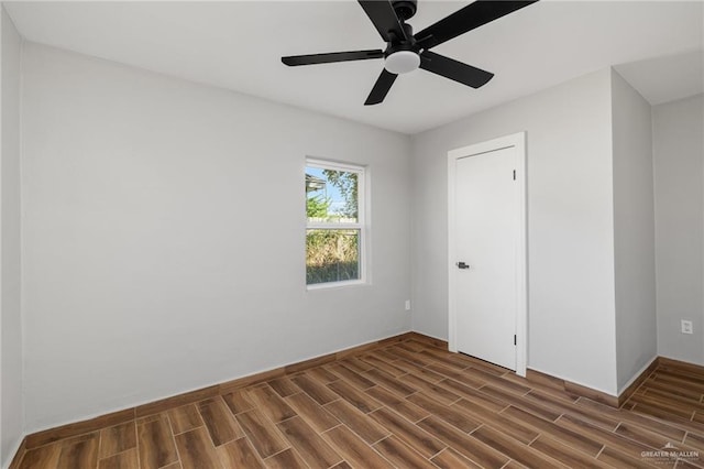 unfurnished bedroom featuring ceiling fan and dark hardwood / wood-style floors