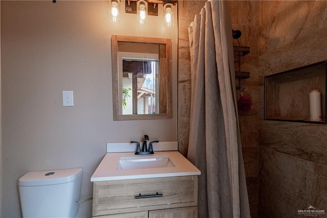 bathroom with vanity, toilet, and a shower with shower curtain