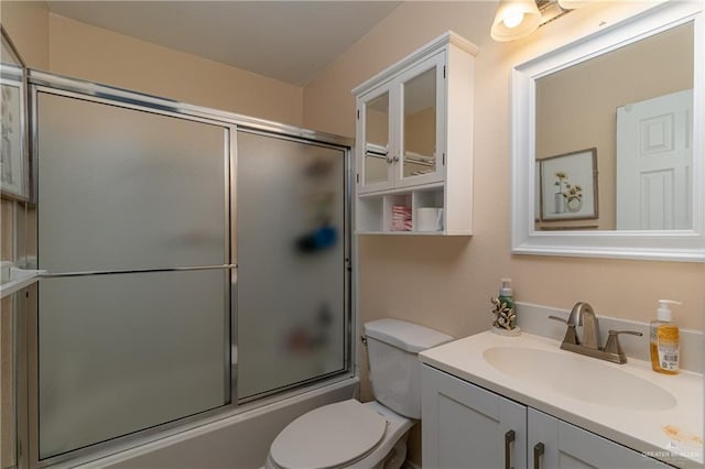 full bathroom with vanity, toilet, and bath / shower combo with glass door