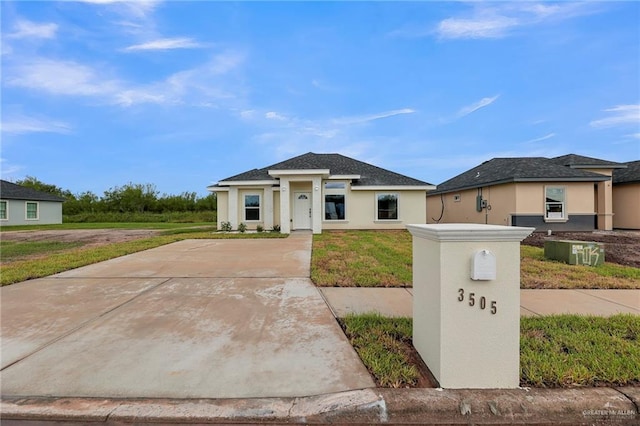 prairie-style house featuring a front yard