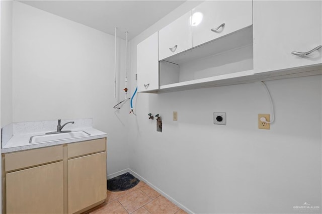 207 E Jackson Ave, Mcallen, TX 78501 - laundry area featuring hookup for a washing machine, electric dryer hookup, light tile patterned flooring, and cabinet space