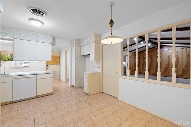 207 E Jackson Ave, Mcallen, TX 78501 - kitchen with white dishwasher, light countertops, hanging light fixtures, and white cabinetry