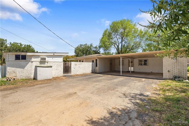 207 E Jackson Ave, Mcallen, TX 78501 - view of front facade with an attached carport and asphalt driveway