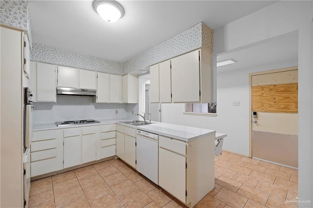 207 E Jackson Ave, Mcallen, TX 78501 - kitchen with white dishwasher, under cabinet range hood, stovetop, light countertops, and a peninsula