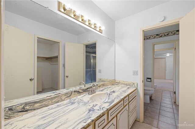 207 E Jackson Ave, Mcallen, TX 78501 - bathroom with vanity, a shower with shower door, and a spacious closet