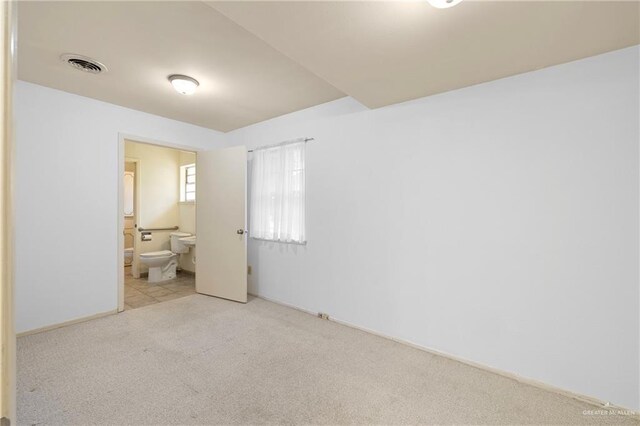 207 E Jackson Ave, Mcallen, TX 78501 - unfurnished bedroom with carpet flooring and connected bathroom