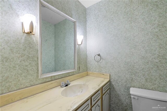 207 E Jackson Ave, Mcallen, TX 78501 - bathroom featuring vanity and wallpapered walls