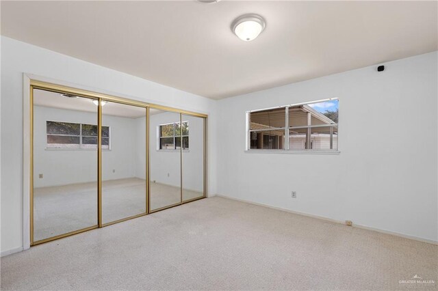 207 E Jackson Ave, Mcallen, TX 78501 - unfurnished bedroom featuring carpet, multiple windows, and a closet