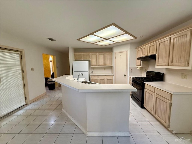 6501 Magnum Rd, Mission, TX 78573 - kitchen featuring black range with gas cooktop, light tile patterned floors, freestanding refrigerator, and light brown cabinets