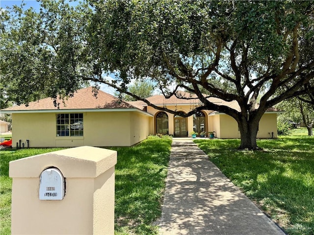 6501 Magnum Rd, Mission, TX 78573 - view of front of property featuring a front yard and stucco siding