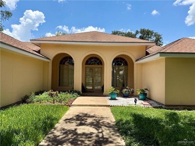 6501 Magnum Rd, Mission, TX 78573 - entrance to property with french doors, roof with shingles, and stucco siding