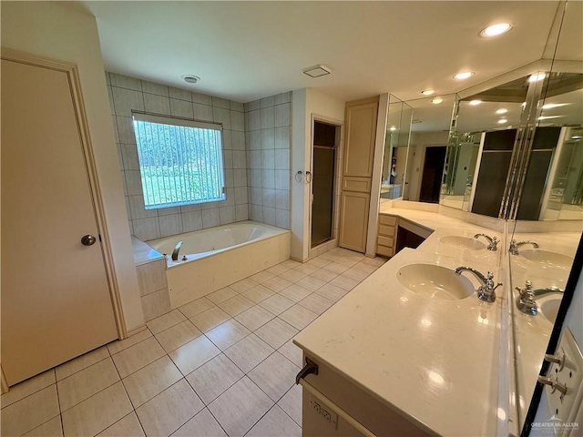 6501 Magnum Rd, Mission, TX 78573 - full bath featuring double vanity, tile patterned floors, a garden tub, a shower stall, and recessed lighting