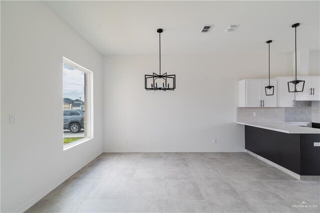 unfurnished dining area with plenty of natural light